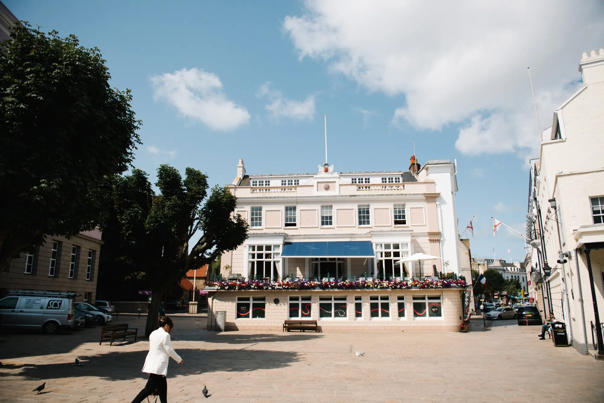 The United Club on the Royal Square, St Helier, with its flower-lined balcony and blue awning