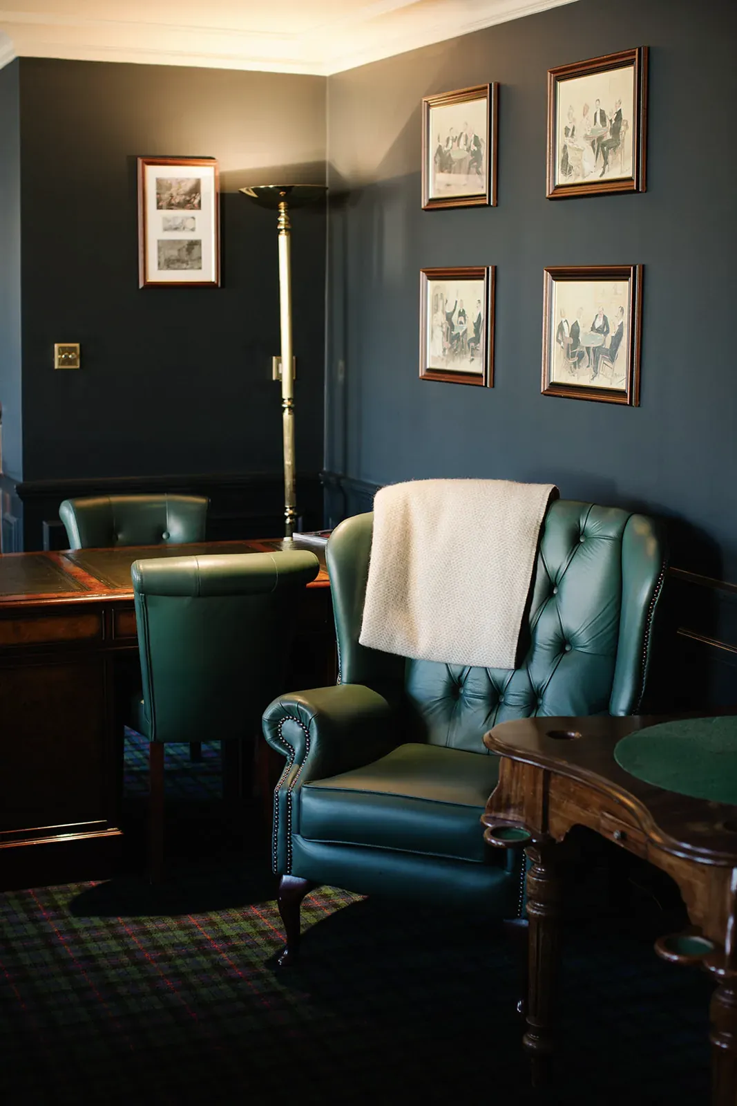 The Heavey Room, with green leather chairs and framed club cartoons